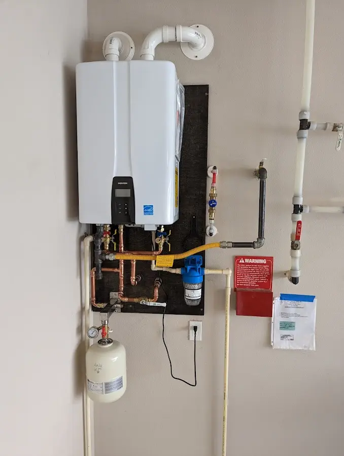 Professional plumber installing copper piping in a Gladwin home